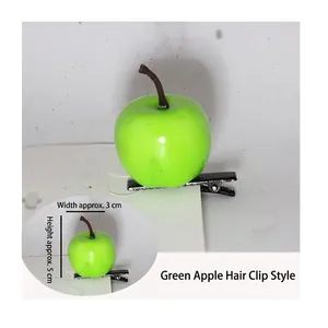 Detail view of a green apple hair clip with size dimensions 3cm width and 5cm height