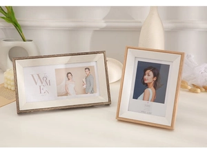 Detail of wooden picture frames in horizontal and vertical layouts with a tiered 3D border