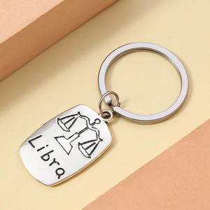 Detail of silver Libra zodiac keychain with black embossed symbol and lettering