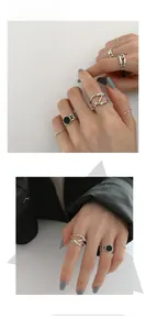 Detail shot of stacked S925 sterling silver rings featuring black enamel and geometric designs