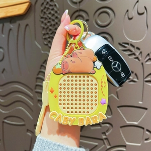 Cute yellow Capybara keychain with magnetic steel bead board held by hand