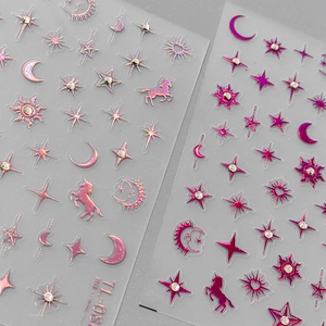 Holographic pink celestial nail stickers with stars, moons, and rhinestone details