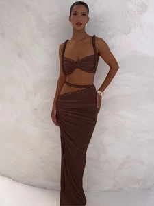 Close-up of the deep brown two-piece set featuring a cropped top and high waist slit skirt