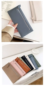 Detailed macro view showing the slim profile and assorted colors of leather zip wallets