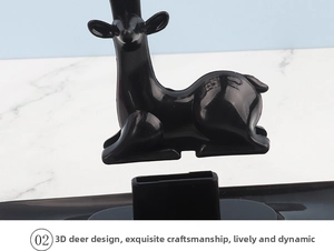 Detail of deer-shaped jewelry organizer with polished black finish and branch antlers