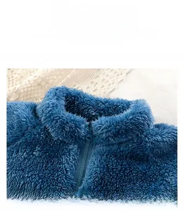 Close-up of kids plush fleece jacket collar in navy blue with sturdy zip-up design