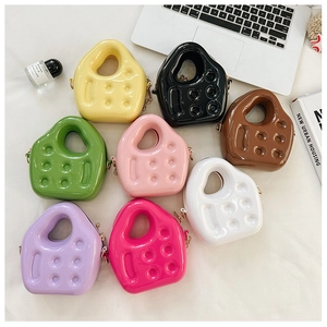 Flat lay of colorful mini PVC jelly bags in eight colors with golden chain straps
