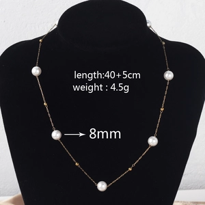 Detail view of pearl necklace on neck with size specs 40+5cm length and 8mm pearl diameter