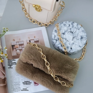 Three stylish handbags featuring chunky gold metal chain straps and mixed textures
