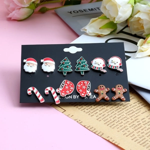 6 pairs of festive Christmas stud earrings featuring Santa, tree, and snowman icons