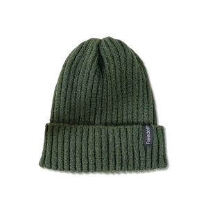 Detailed view of dark green rib-knit beanie with Freedom textile label and thick texture