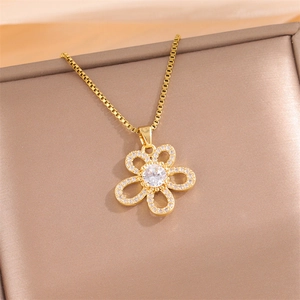 Golden flower pendant necklace with cubic zirconia on a premium leather jewelry box