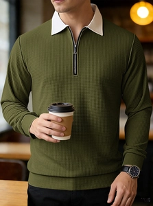 Detail of army green waffle knit texture and zipper collar on men's polo shirt