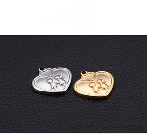 Detail view of gold and silver heart pendants featuring hand-holding couple engraving