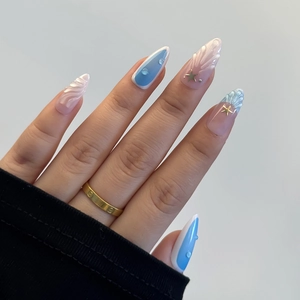 Detail of 3D shell and starfish charms on light blue gradient almond press-on nails