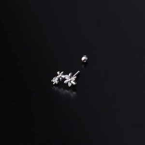 Silver flower helix stud earring with sparkling crystals and screw ball back on black background