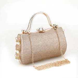 Detail of gold evening clutch with pearl fringe, rhinestones and elegant chain strap