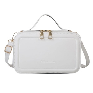White faux leather handbag with embossed fashion logo and golden zippers on white background