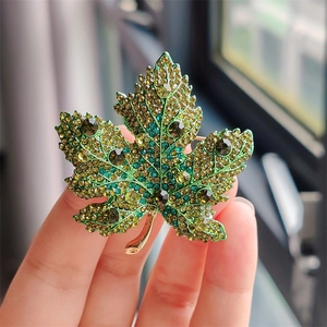 Elegant gold maple leaf brooch with green and amber crystals for luxury suits and coats