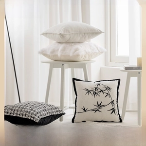 Detail view of beige luxury pillow covers featuring faux fur and modern patterns