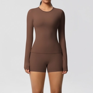 Detailed texture of dark brown long-sleeve yoga top and high-waist sports shorts set