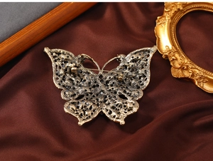 Detailed back view of vintage bronze butterfly brooch showing secure pin mechanism