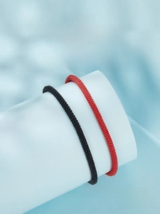 Detail of woven rope bracelets in black and red with S925 sterling silver hardware