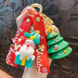 Cute festive Christmas Santa Claus and Christmas tree silicone keychain with a red hand strap.