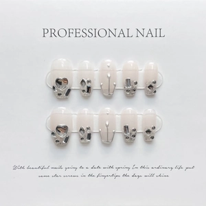 Handmade press-on nail set with translucent pink base and 3D silver heart rhinestones