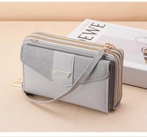 Detailed side view of grey leather phone crossbody bag with triple-layer zipper structure
