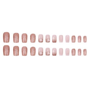 French glitter press-on nails set with rose gold sparkles and white heart patterns