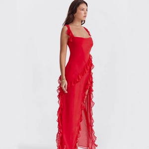 Detail view of red chiffon maxi dress with ruffled trim and high leg slit design