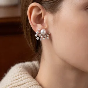 Elegant silver fireworks earrings with pearls and zircon stones shown on model