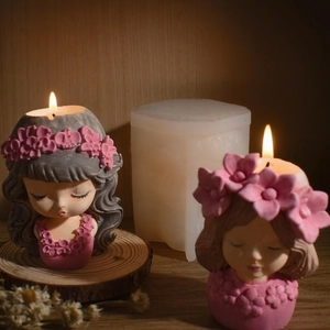 DIY fairy girl silicone mold with finished floral scented candles on a wooden table