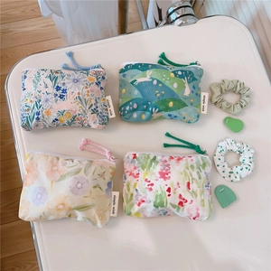 Detailed flat lay of floral cotton mini purses with cute rabbit patterns and zip closure