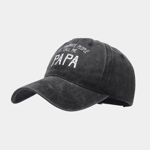 Detail view of washed cotton fabric texture and printed slogan on charcoal baseball cap