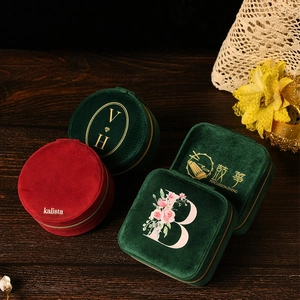 Detail of velvet jewelry organizers in round and square shapes with gold foil logo