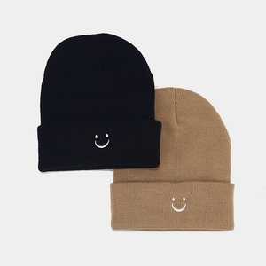Minimalist knit beanie with smiley face embroidery in black and khaki colors