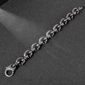 Detail of vintage oxidized steel chain link bracelet with ornate floral engraved clasp