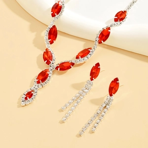 Macro shot of red marquise crystal necklace and matching tassel earrings jewelry set