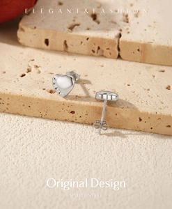 Macro detail of S925 sterling silver heart earrings with micro-set cubic zirconia stones