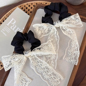 French vintage white lace bow hair scrunchies with long ribbons on a decorative tray