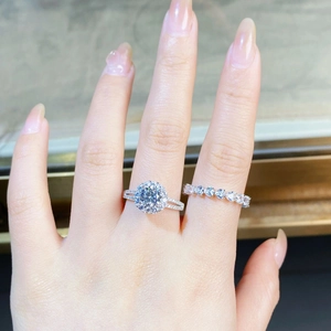 Detail of 925 sterling silver 1ct moissanite ring and wedding band on hand