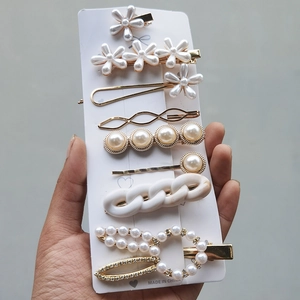 Detail of candy color hair clip set with pearls and marble patterns on display card