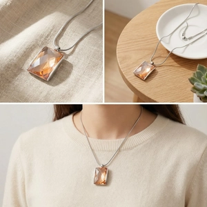 Detailed views of amber geometric pendant on a sleek snake chain necklace