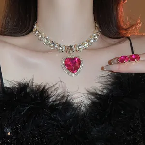 Luxe geometric necklace and earring set with pink heart-shaped crystals on model