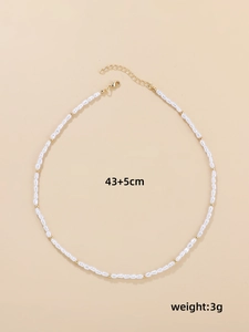 Detailed view of baroque pearl necklace with gold beads and length measurements