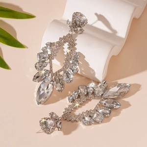 Sparkling silver flower drop earrings with rhinestones on a minimalist display stand