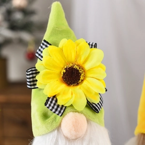 Macro detail of gnome plush featuring a sunflower hat with black and white bow ribbon