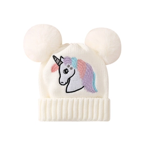 Winter knitted hat for girls featuring unicorn embroidery and dual white faux fur pom-poms